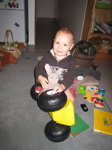 Owen likes steering wheels. Since his plastic trike has handle bars, he flipped it sideways and uses one of the rear wheels as a steering wheel. Slackjack Bunny often rides along. Owen provides the engine noise.